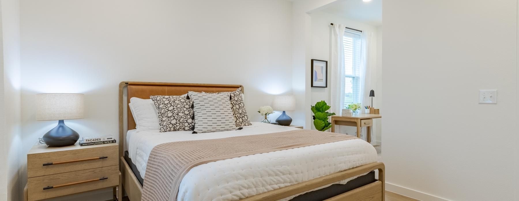 a bedroom with a bed and lamps