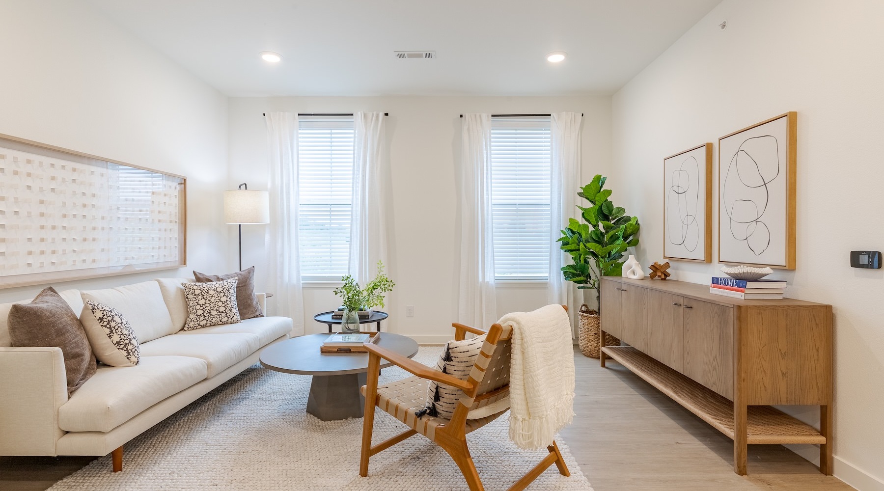 living room with seating tables and a plant
