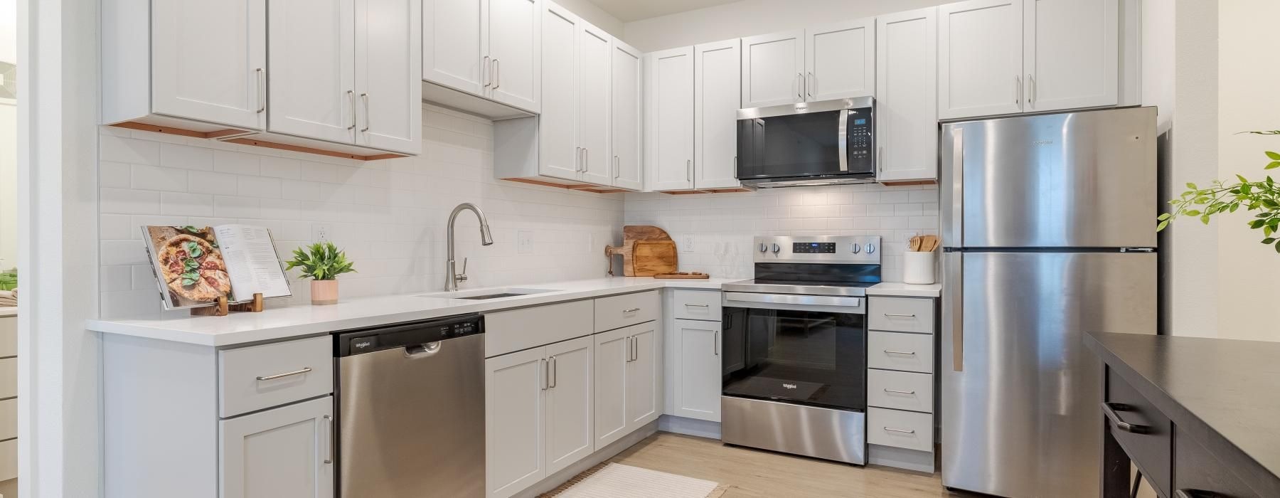 a kitchen with white cabinets